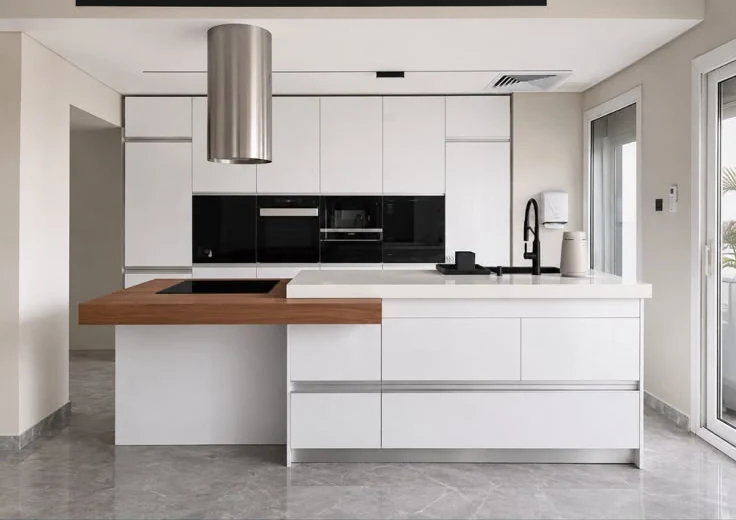 White kitchen with a walnut breakfast counter