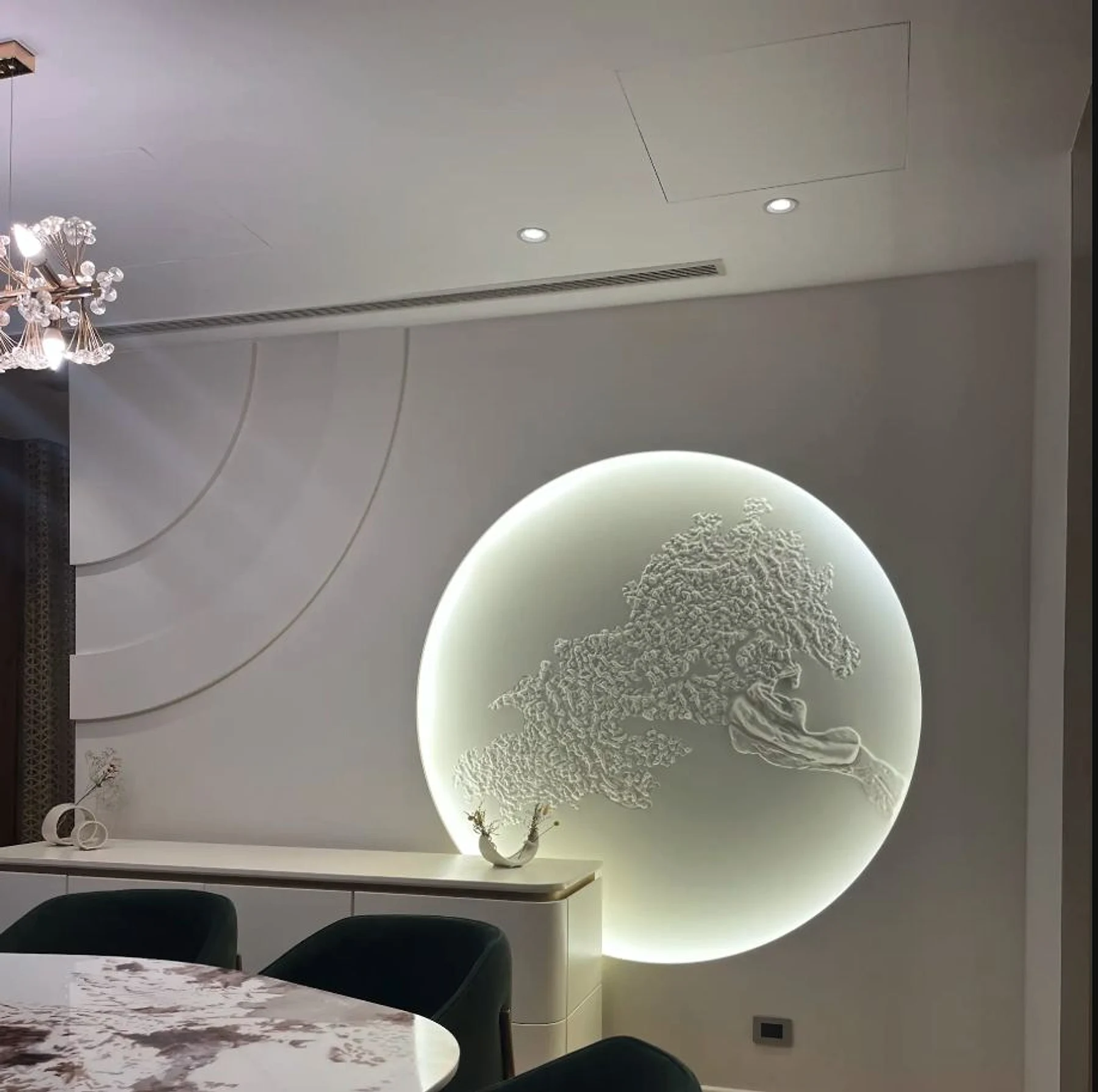 A dining wall where sculptural light and curved detailing establish the SODIC arrival.